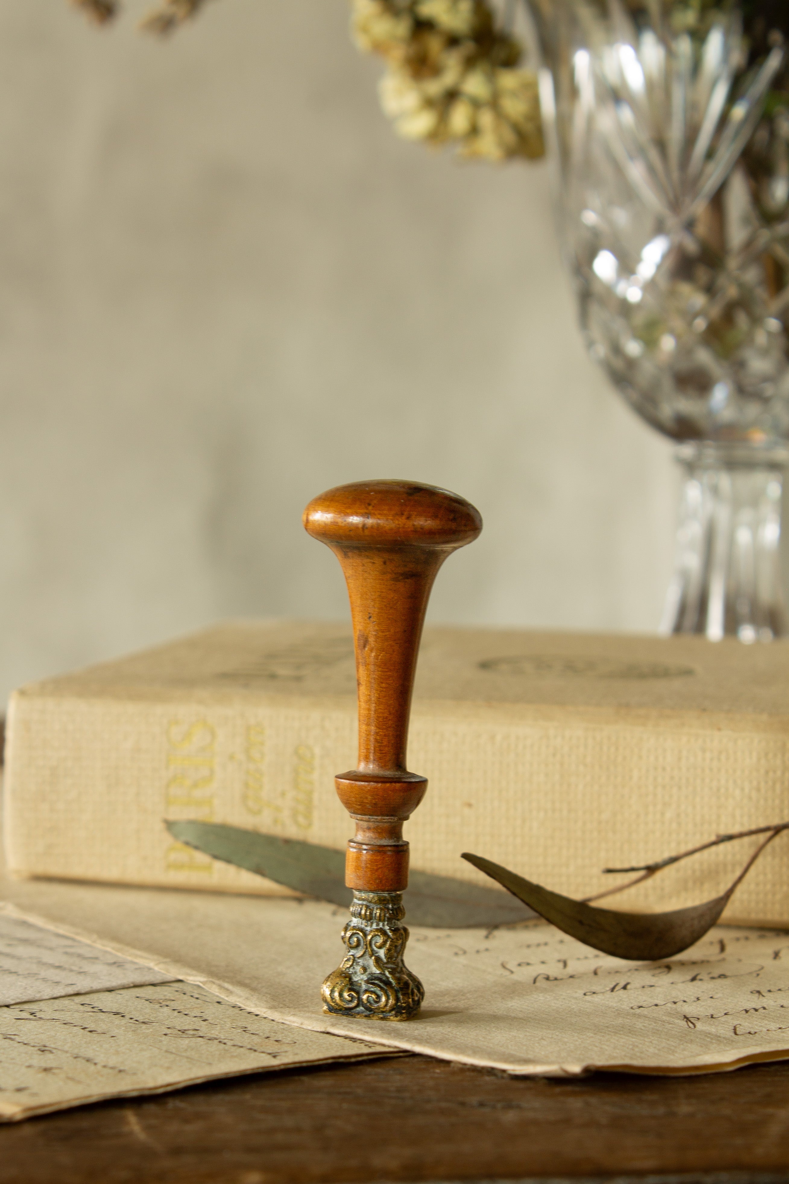 Antique French wax seal sourced in Paris, with hand-turned wooden handle, scrolled brass or bronze-alloy stamp head, and engraved monogram, L and D.