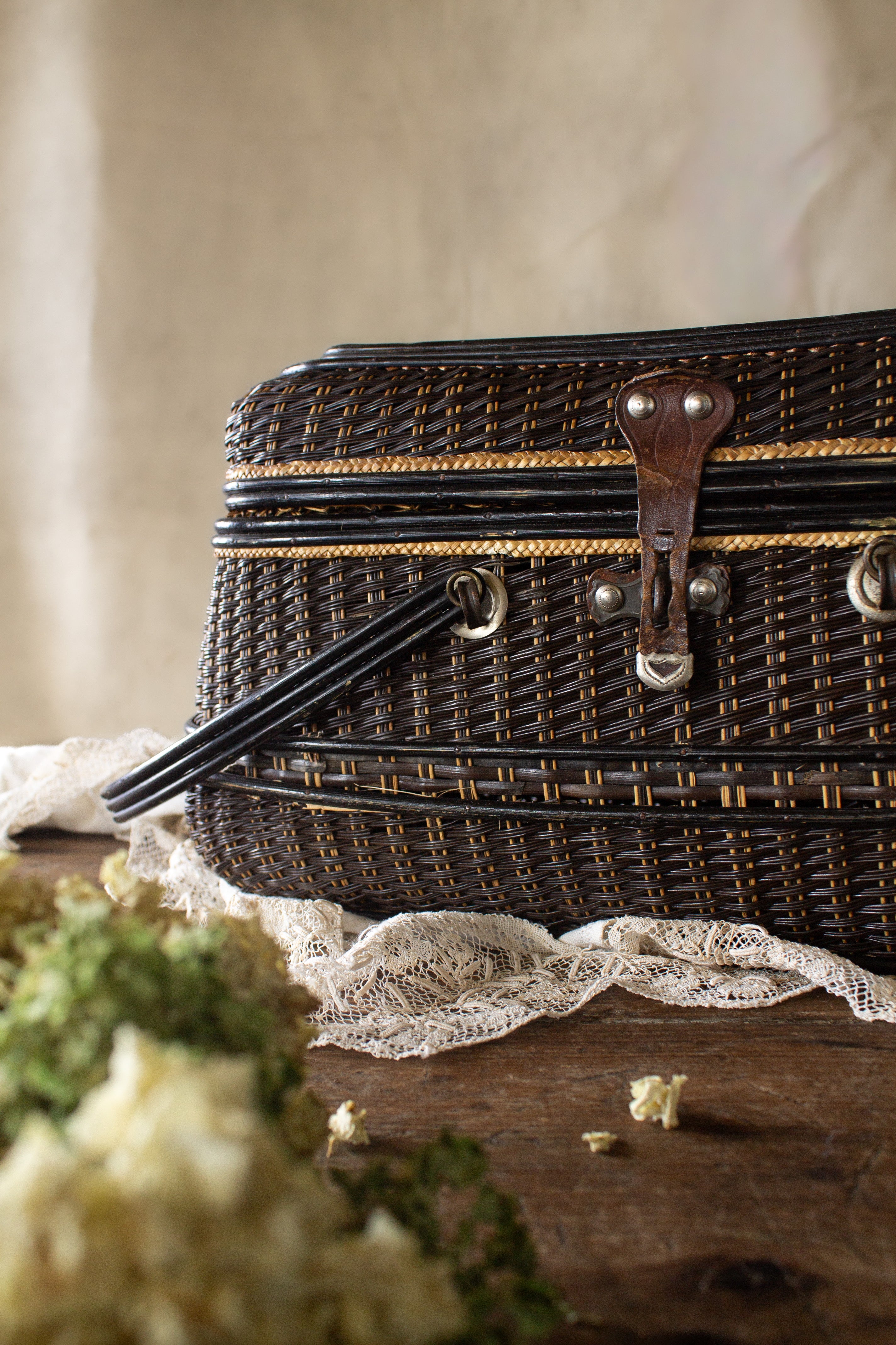 Antique English wicker fishing creel basket with leather latch, sourced in France.