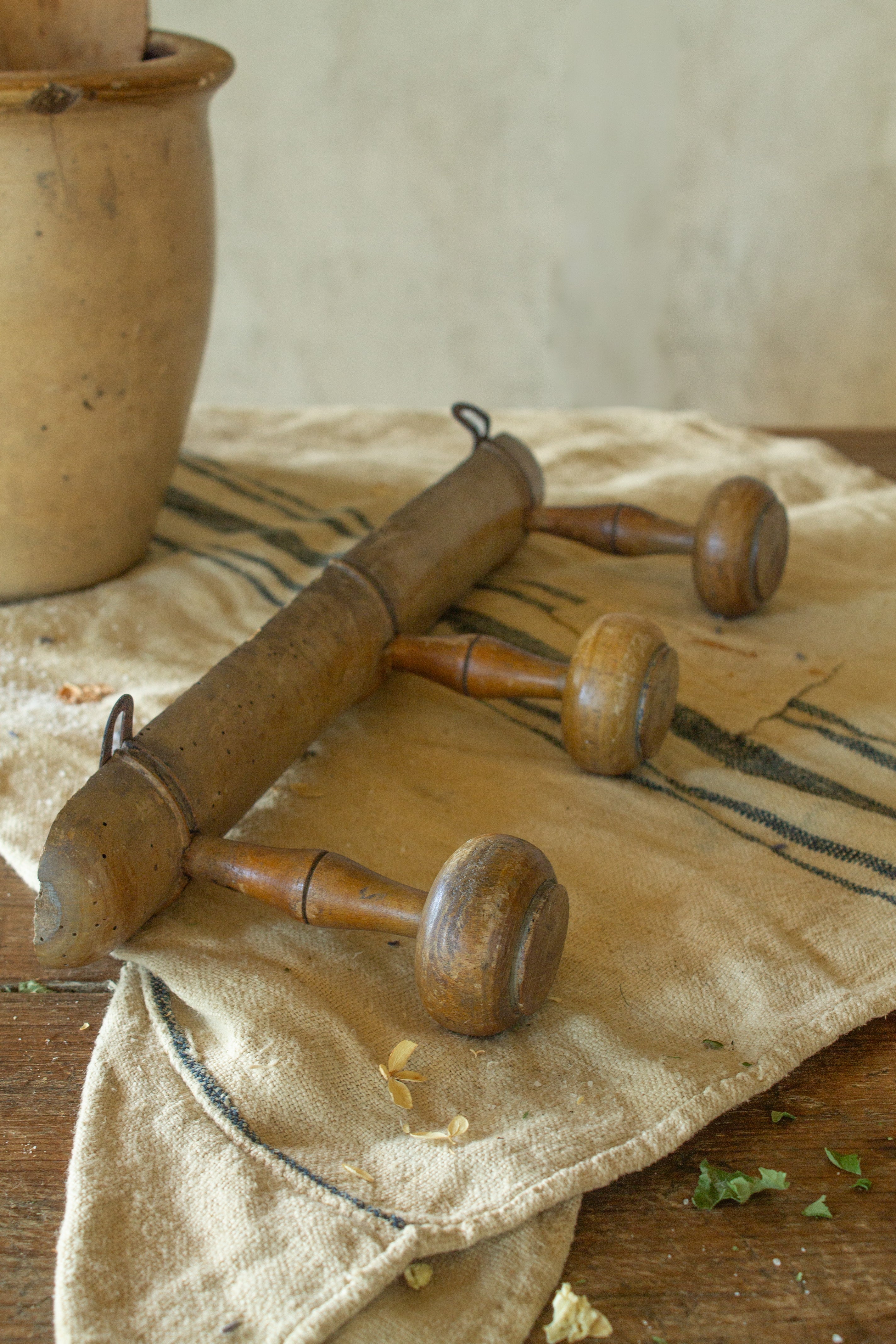 Antique French faux bamboo three peg wooden coat rack with turned pegs and old metal hanging hardware.