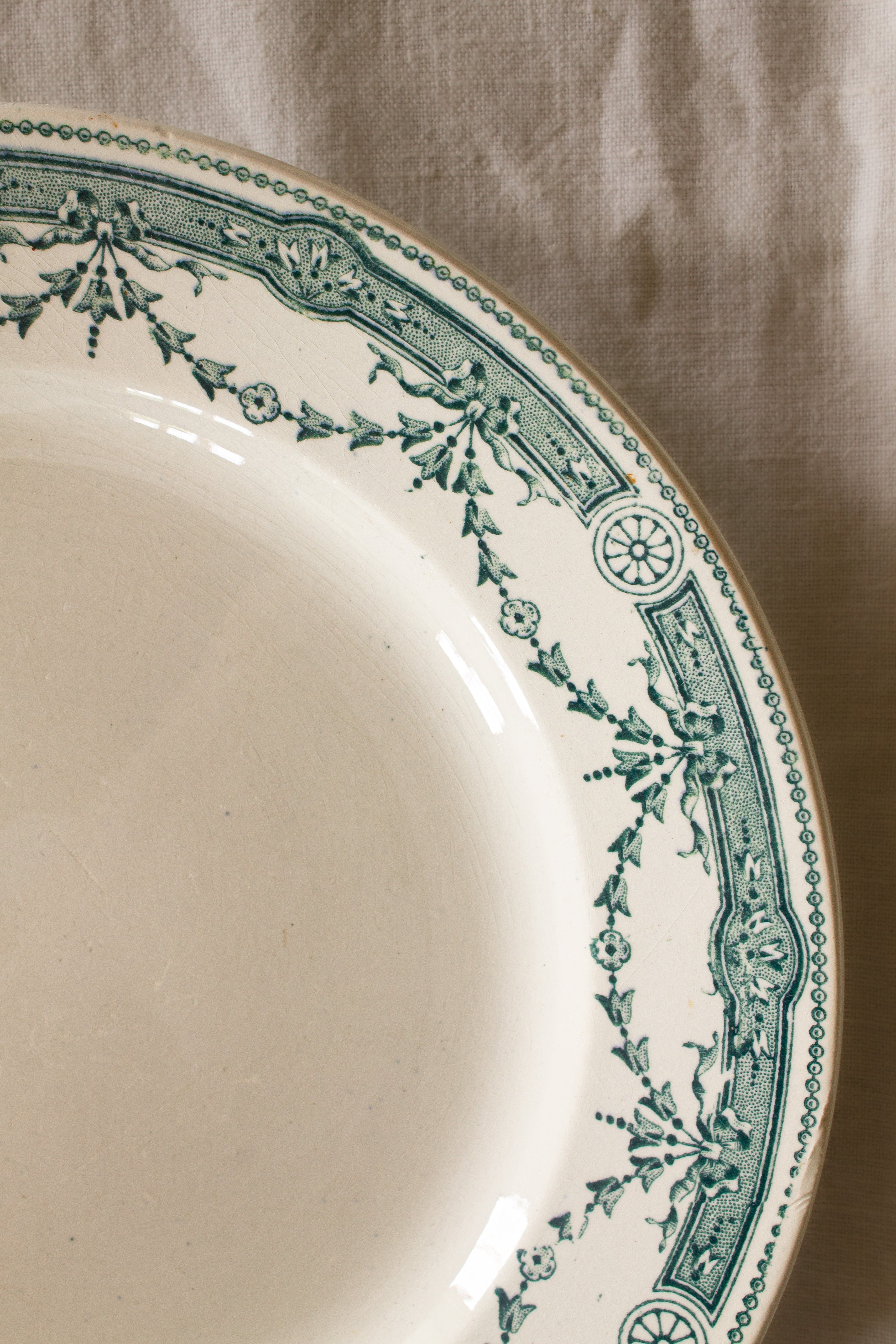 Antique French Moulin des Loups Provence ironstone plate with green transferware floral border, sourced in France.