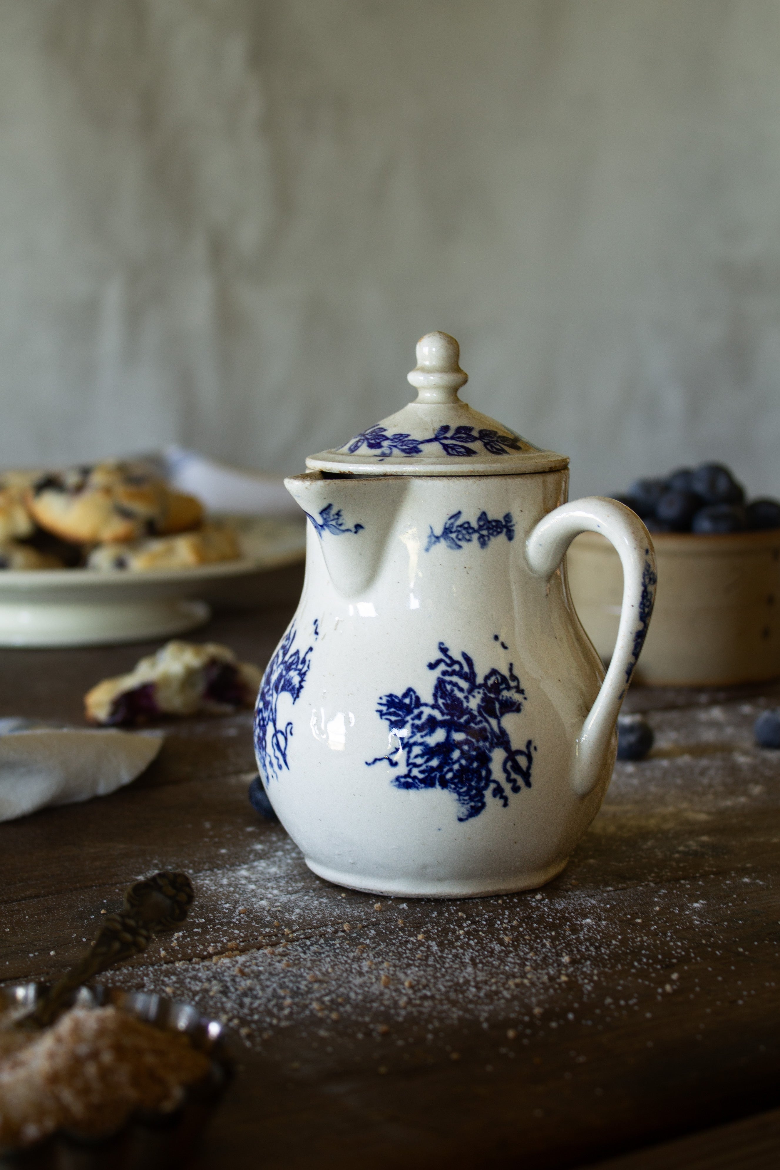 Antique French Saint-Uze style lidded creamer with cobalt-blue floral decoration and creamy glazed ceramic body.