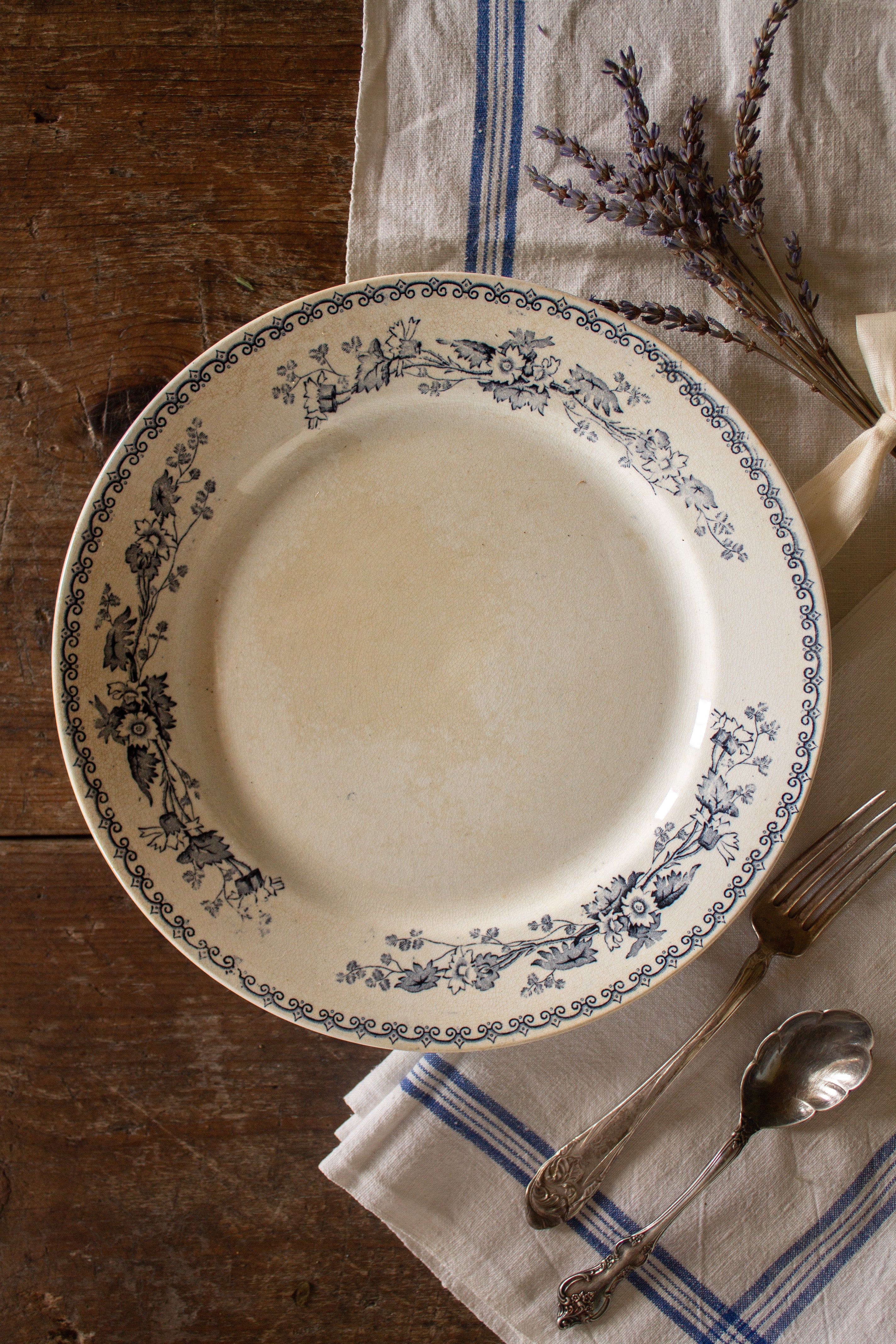 Antique French Sarreguemines Bertha blue floral transferware plate styled on rustic wood with linen and lavender.
