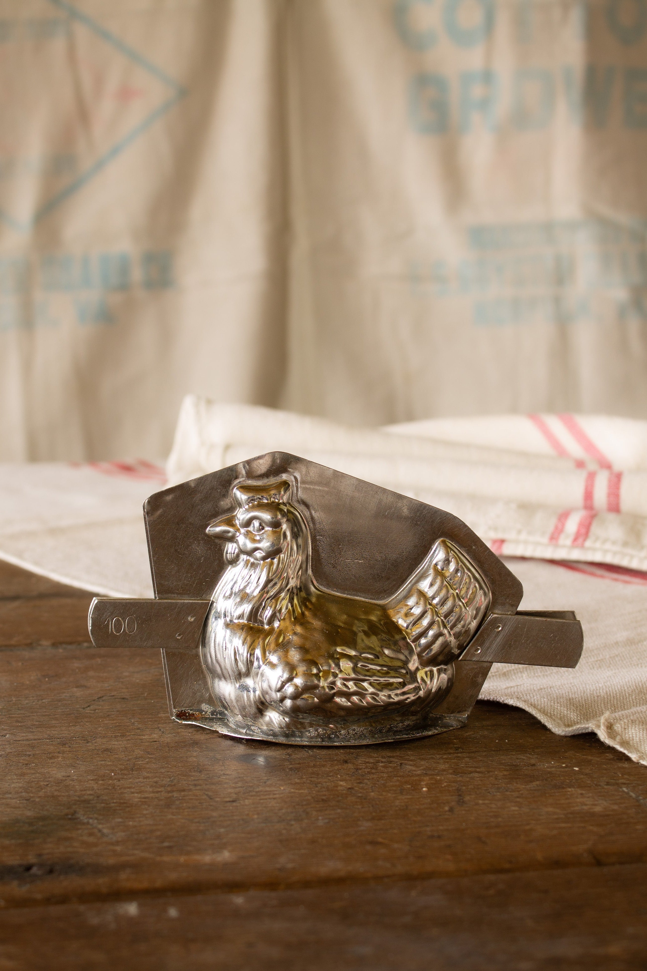 Vintage French metal chicken chocolate mold sourced in Paris with two-part hen form, raised feather details, and side bar closure.