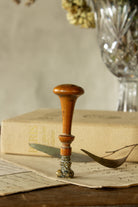 Antique French wax seal sourced in Paris, with hand-turned wooden handle, scrolled brass or bronze-alloy stamp head, and engraved monogram, L and D.