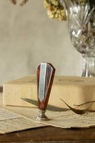 Antique French wax seal sourced in Paris, with faceted faux tortoiseshell handle, silver-tone metal stamp head, and engraved interlaced monogram, possibly A and C.