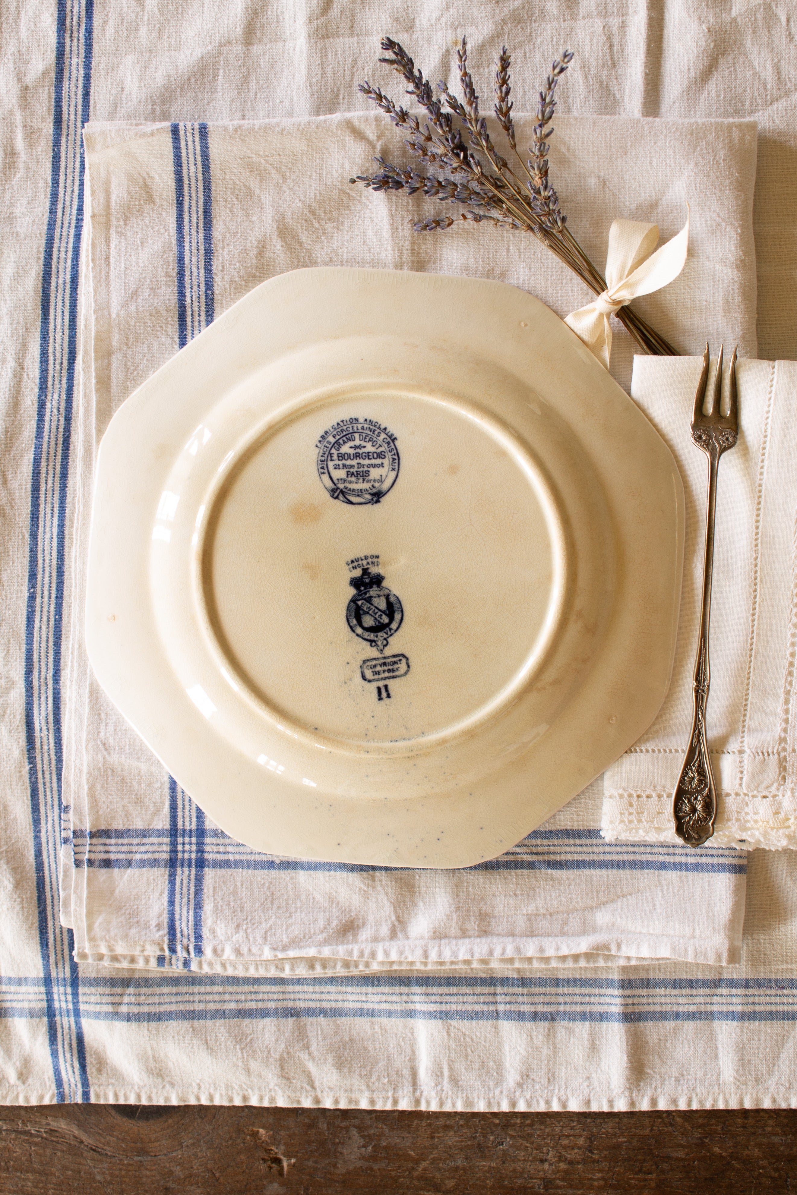 Reverse of antique Canova plate showing Cauldon England and E. Bourgeois Paris backstamps on crazed cream glaze.