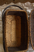 Open antique wicker fishing creel basket showing the woven interior and original structure.