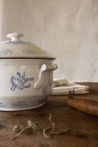 Antique French blue floral ironstone soupière with lid, flower finial, side handles, and beaded band detail.