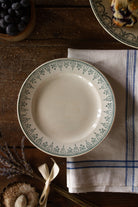 Antique French cream plate with delicate green transferware scroll and floral border decoration.