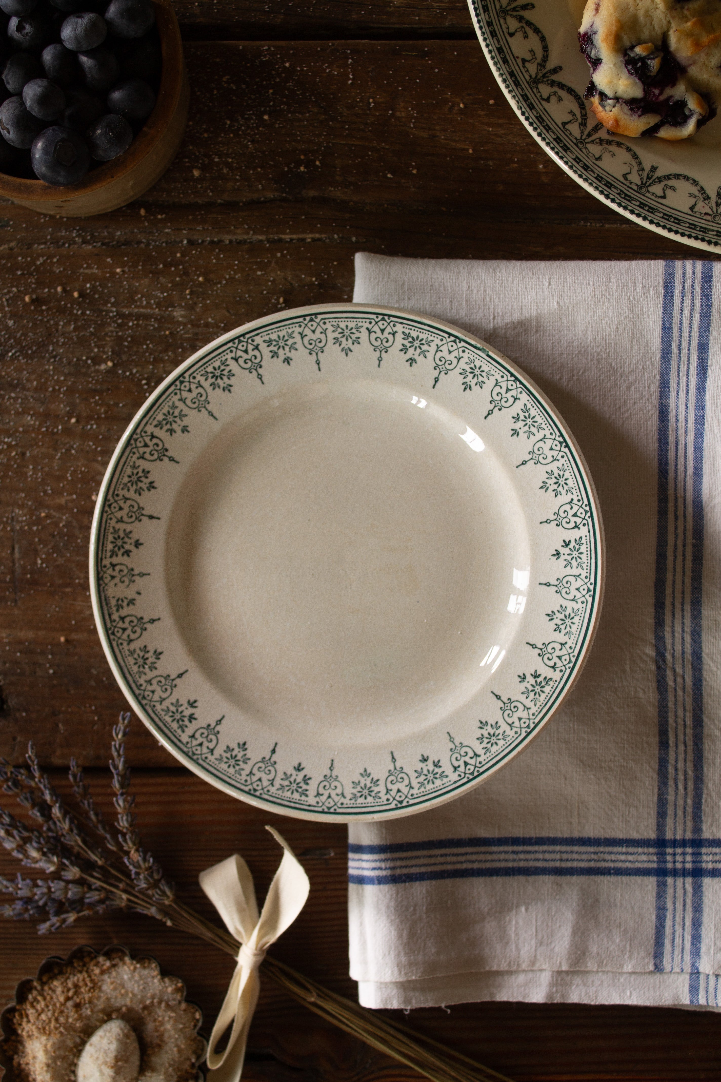Antique French cream plate with delicate green transferware scroll and floral border decoration.