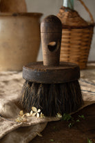 Antique French horsehair work brush with dark wooden handle and round bristles.