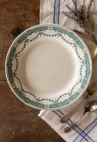 Antique French Moulin des Loups Provence ironstone plate with green transferware floral border, sourced in France.
