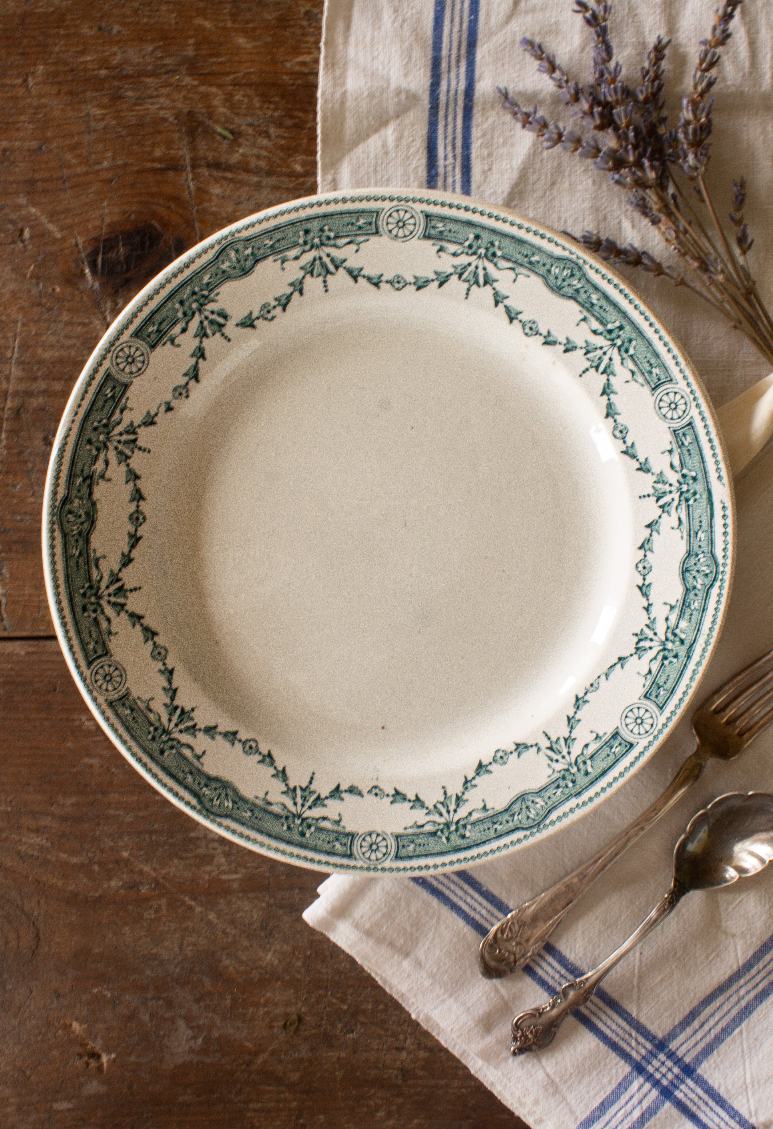 Antique French Moulin des Loups Provence ironstone plate with green transferware floral border, sourced in France.