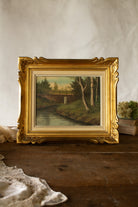 Antique French oil landscape in gilt palmette frame with relined canvas, riverside scene, and old Marseille label on back.