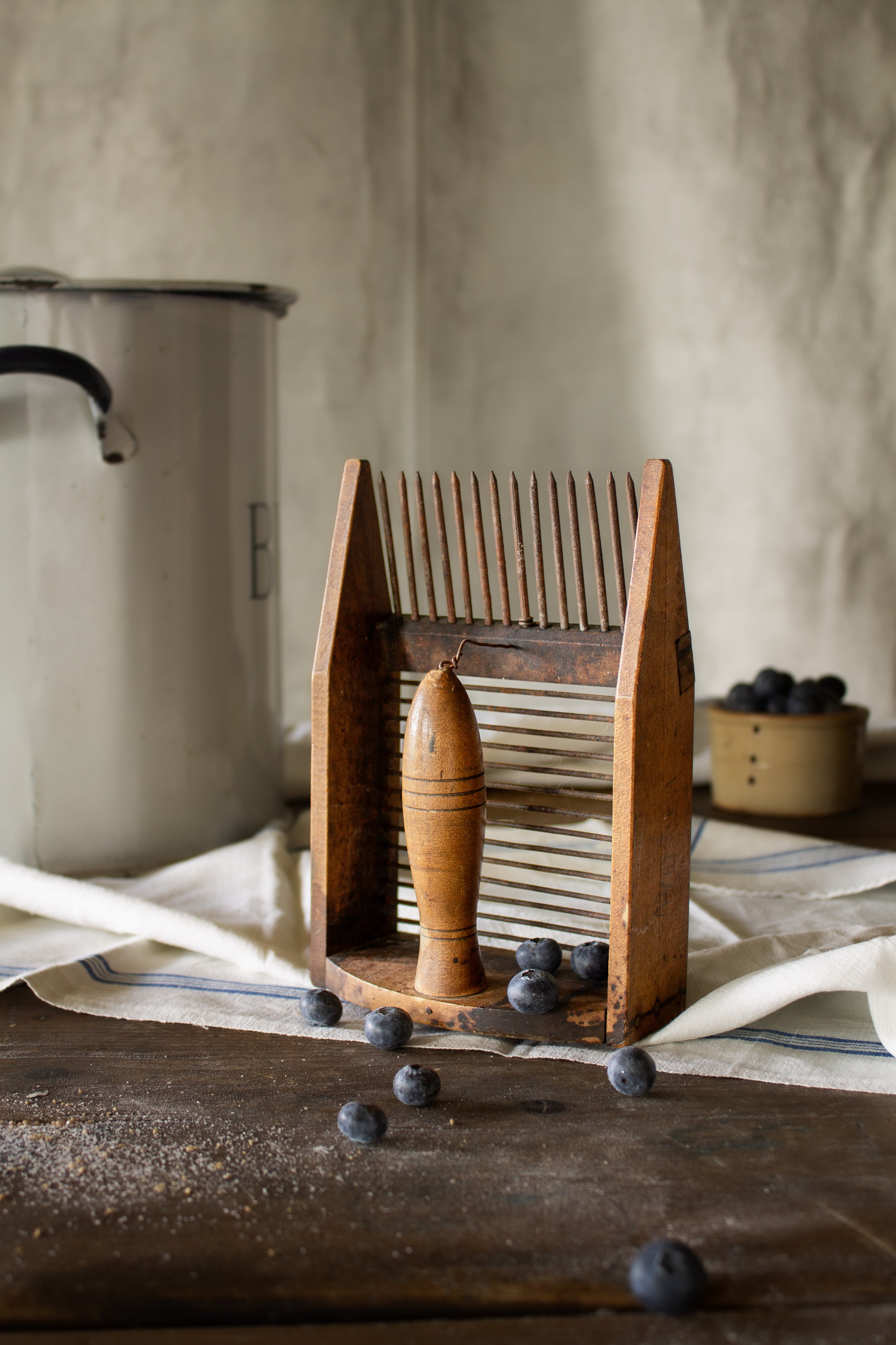 Antique French peigne à myrtilles blueberry comb with wooden frame, turned handle, iron teeth, and metal gathering rods.