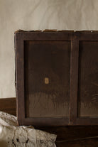 Back of antique French oil painting on old canvas with wooden stretcher, nails, age wear, and visible repair.