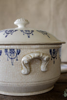 French blue and white lidded tureen with creamy crackled glaze and side handles.