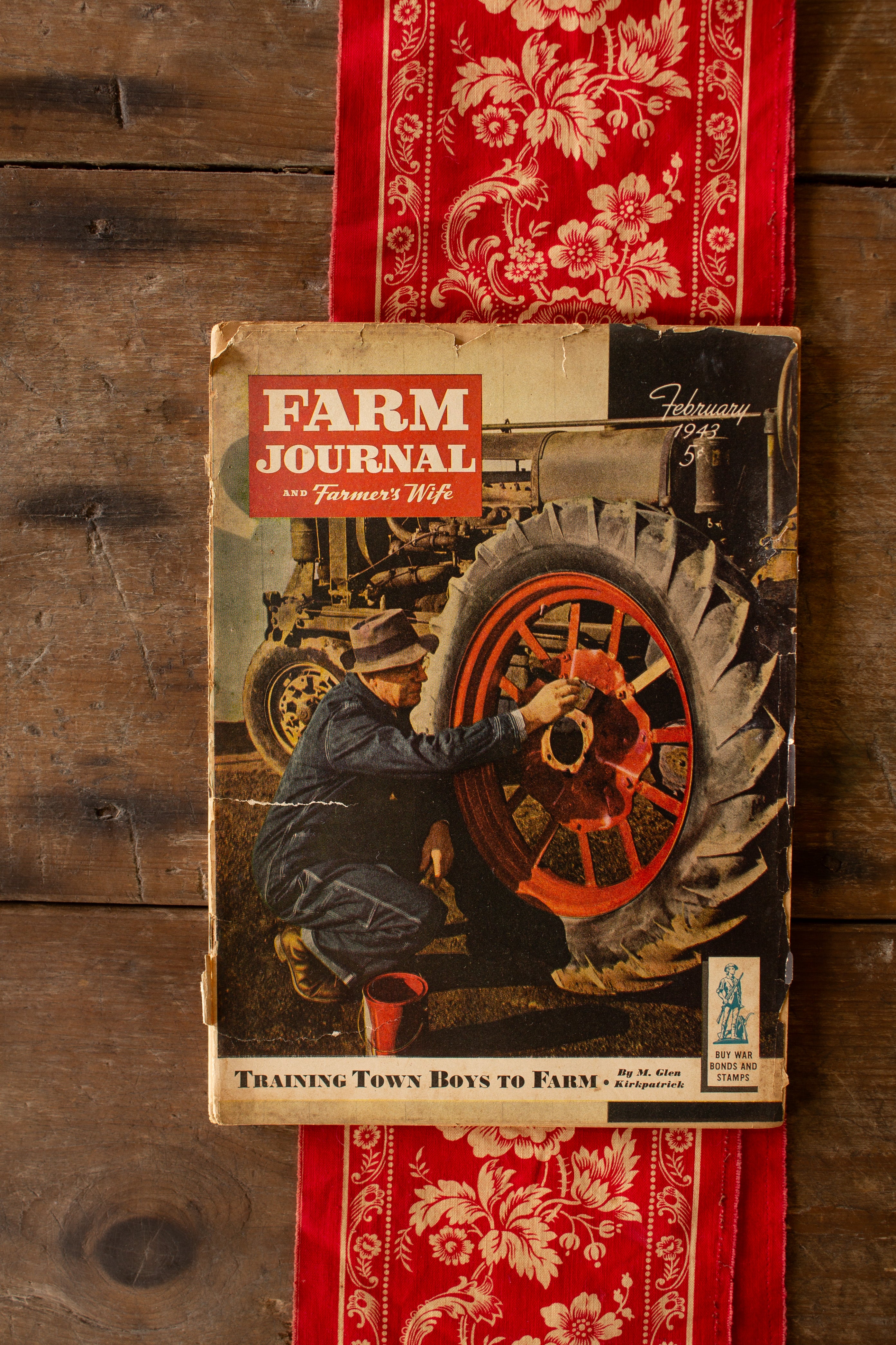 Vintage February 1943 Farm Journal and Farmer’s Wife wartime farm magazine with illustrated tractor cover and Buy War Bonds and Stamps notice.