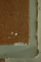 Back of a small vintage painting on board showing age, texture, and wear from earlier use.