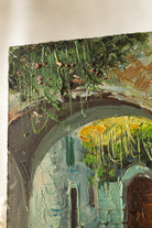 Close detail of thick palette-knife texture on a vintage courtyard painting with green vines and stone archways.