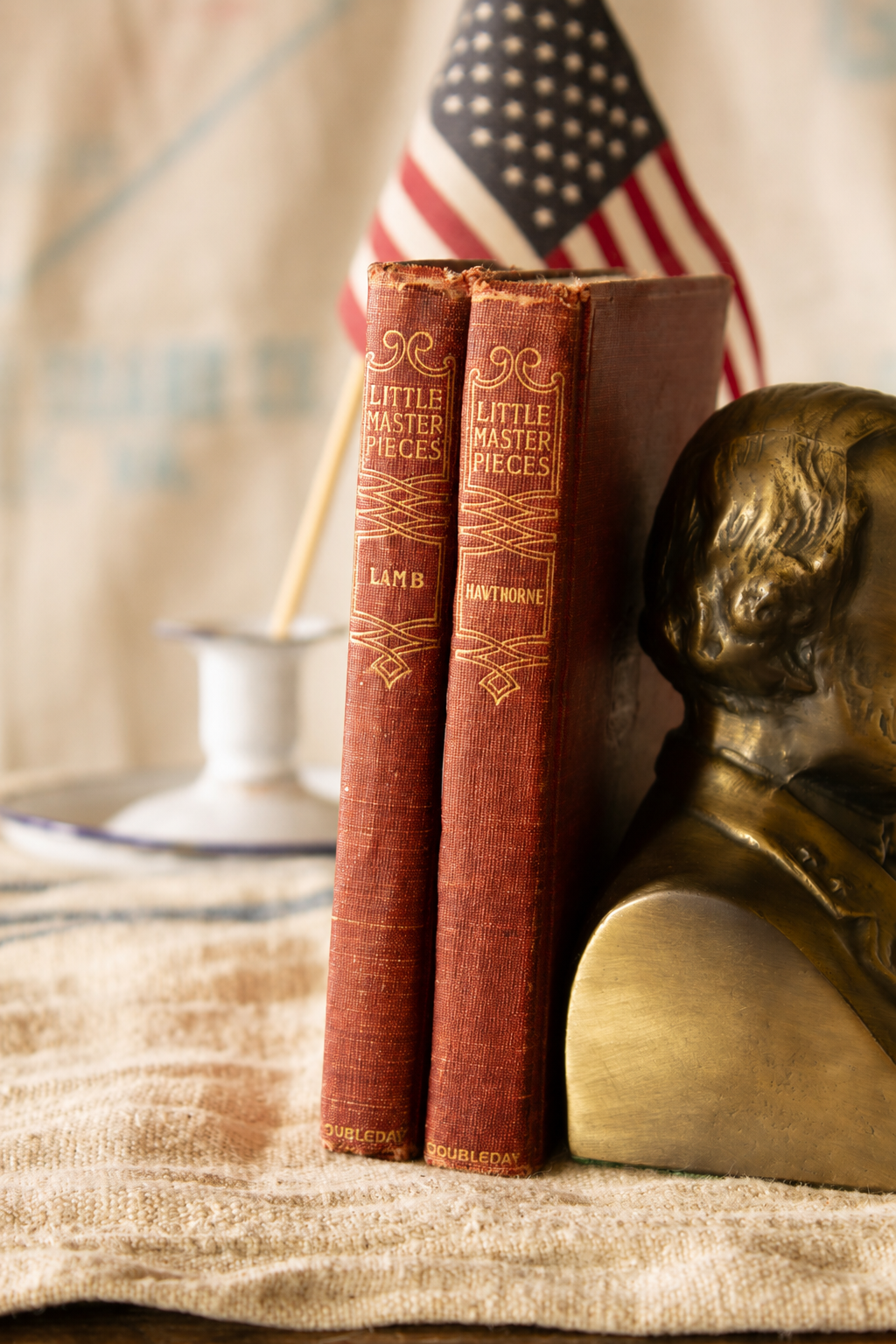 Pair of 1903 Little Masterpieces red cloth books by Nathaniel Hawthorne and Charles Lamb with gilt spines, portrait plates, and worn antique book covers