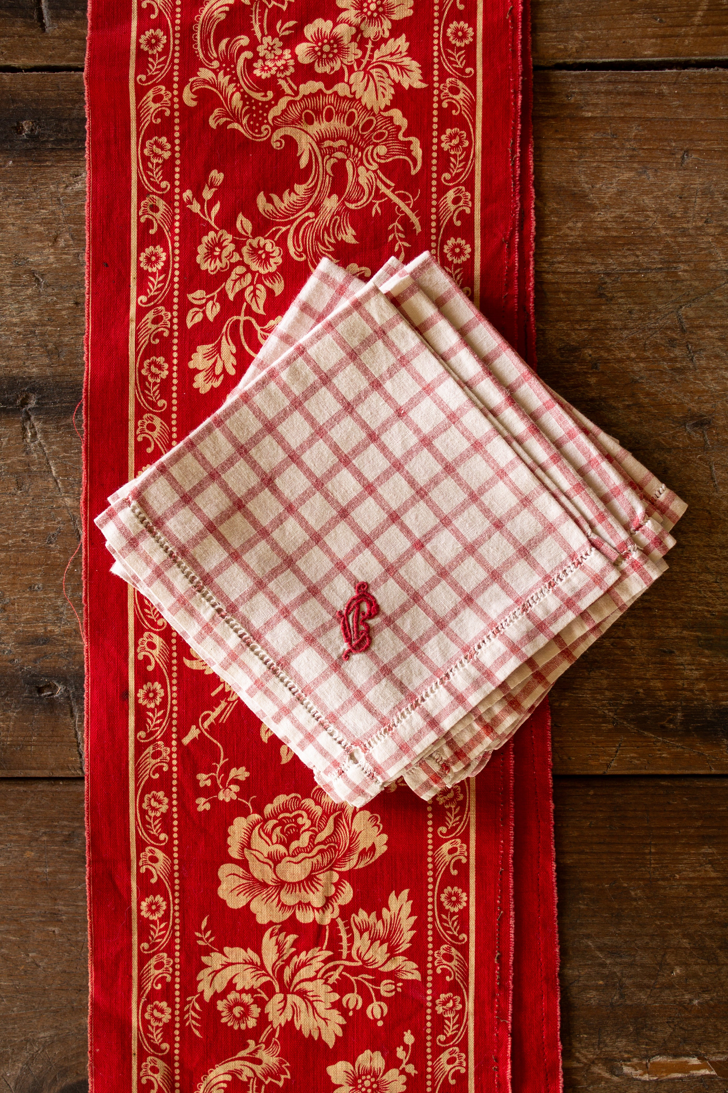 Set of six antique French red check monogrammed tea napkins with hand-embroidered red monograms and drawn-thread hemstitch borders.