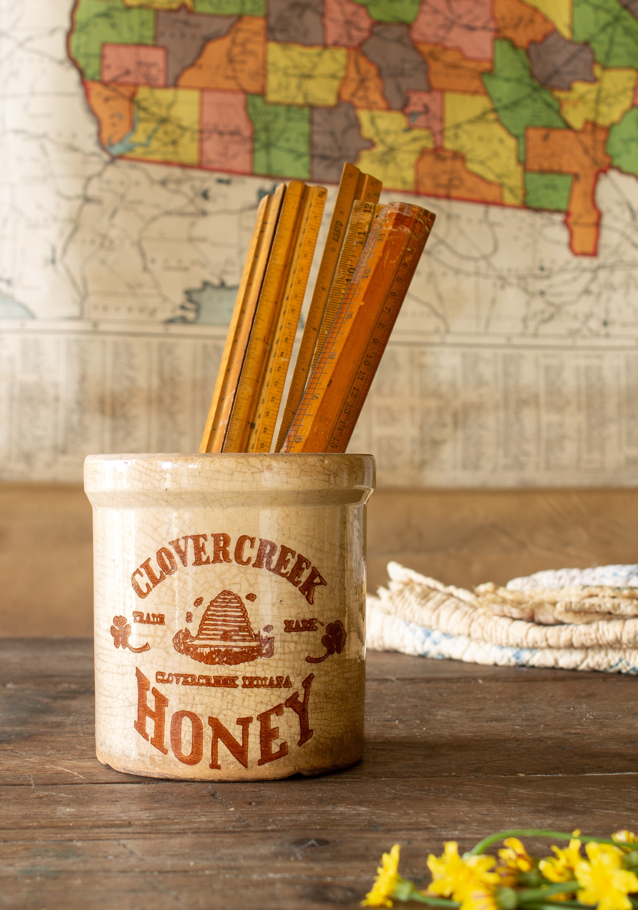 Vintage Clovercreek Honey stoneware crock with beehive decoration, warm staining, and allover glaze crazing.