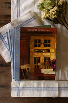 Vintage set of three Time-Life American Country books including Folk Art, The Country Home, and Country Furniture styled on blue and white linen, featuring primitive country, Americana, folk art, pottery, early American furniture, and country interior design reference.